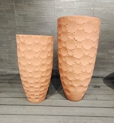 Warm Earthy Terracotta Tone Round Fiber Clay Planter With Rounded Tiles Arranged